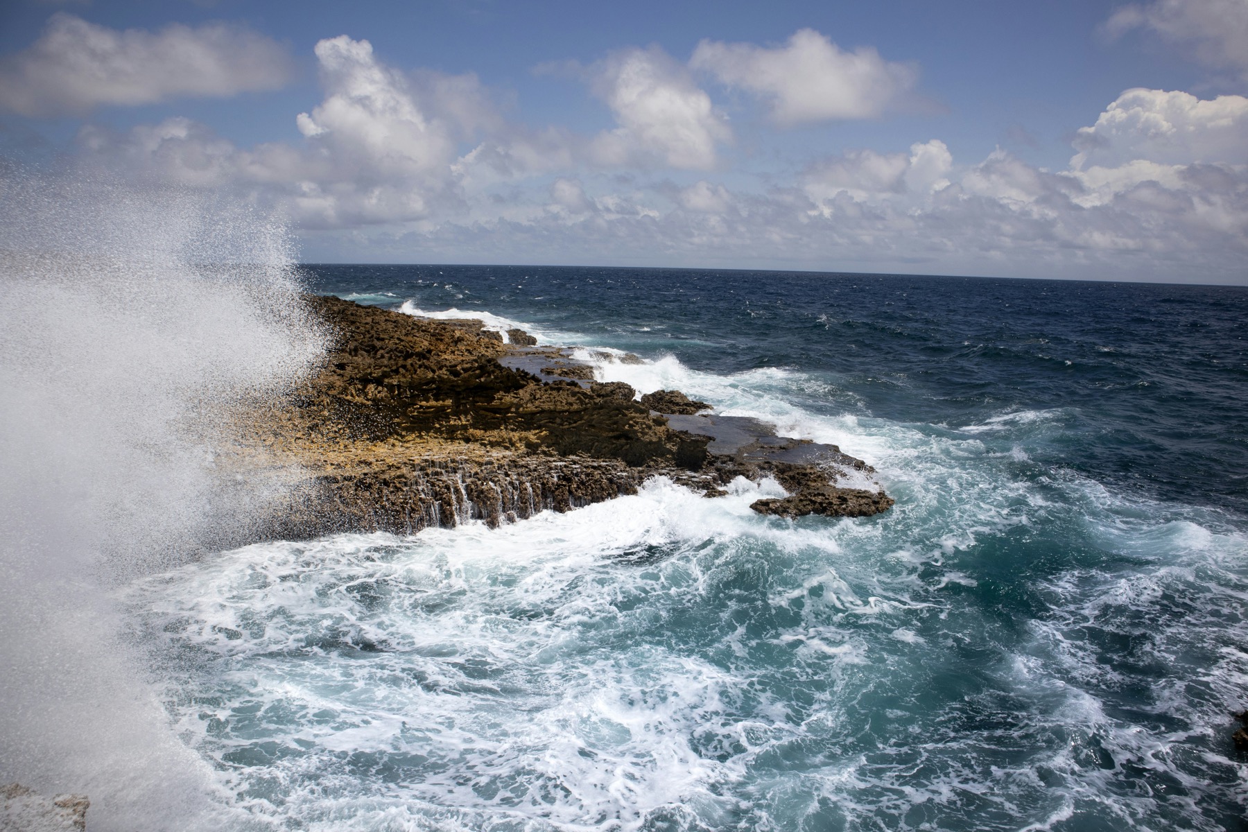 Waves crashing on Curaçao's rugged coastline